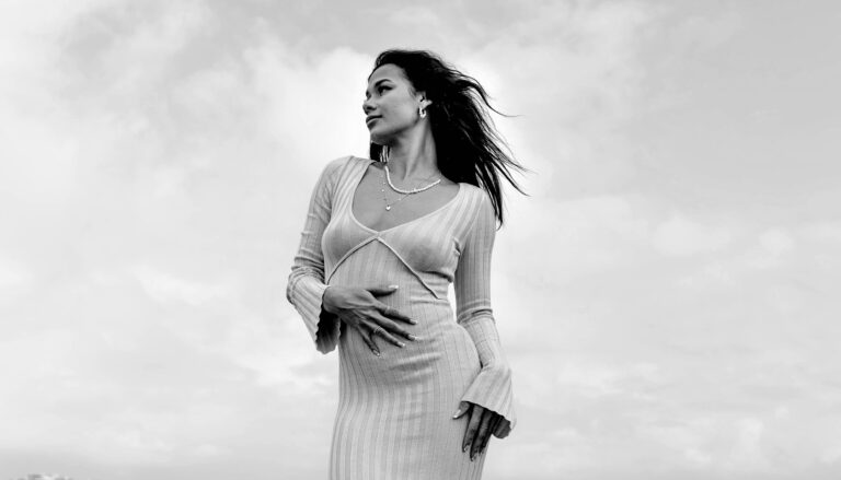 Elegant single woman standing by the beach