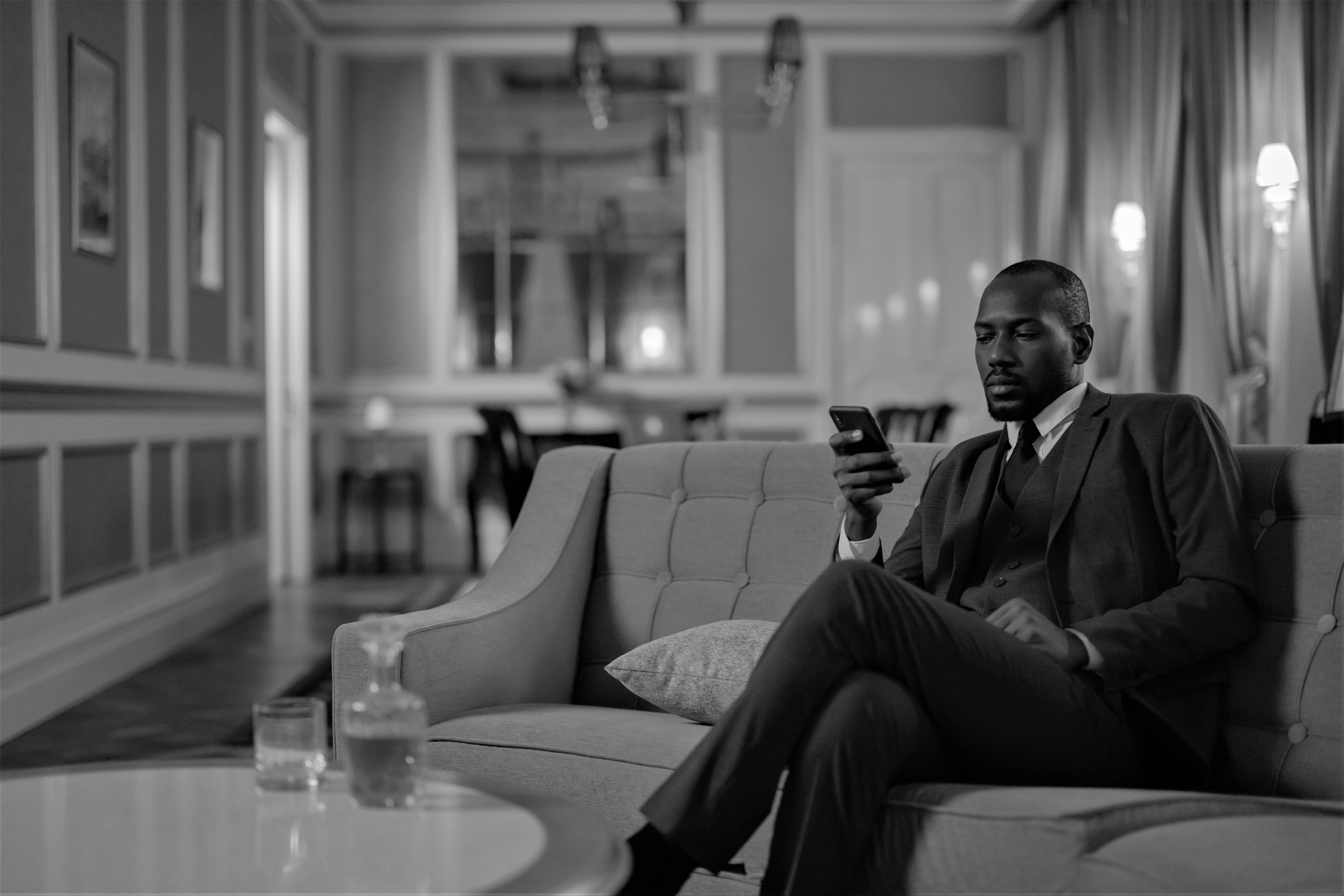 Black man in suits sitting down