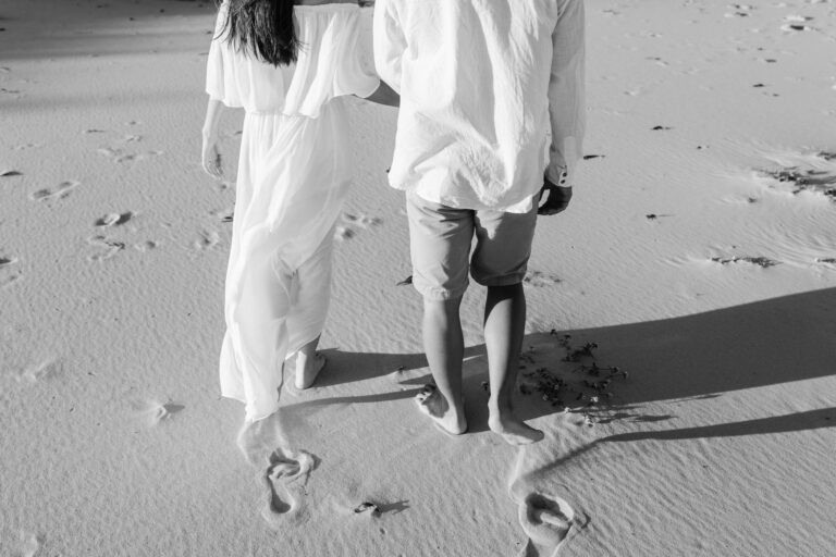 A couple walking on a sandy beach