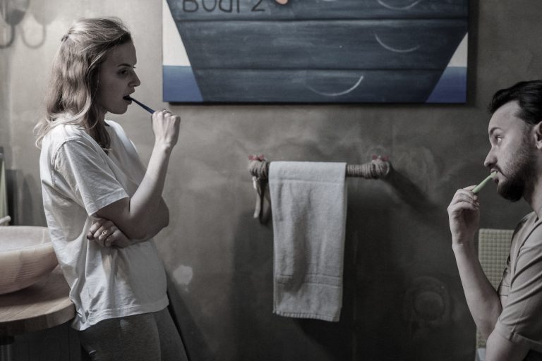 couple evening routine brushing their teeth in the bathroom together