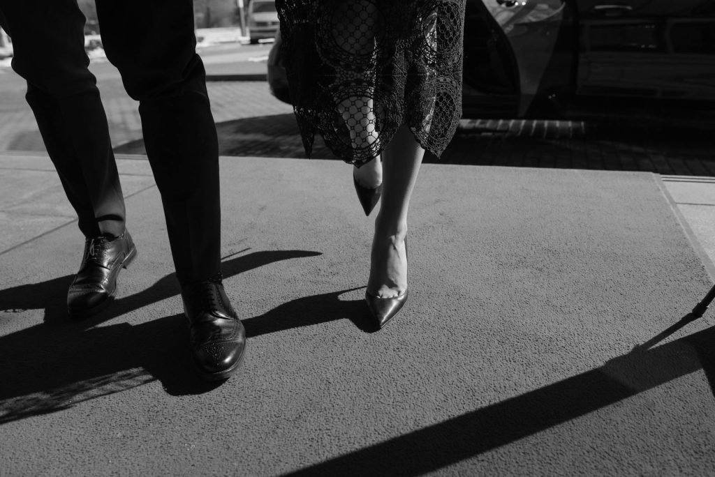 A wealhty man walking on a red carpet with a beautiful women.